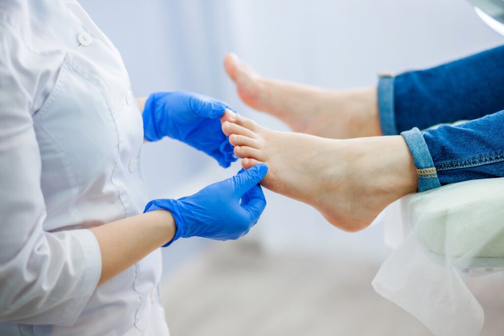Podiatrist examining a patient's foot, emphasizing foot health and treatment options at Emerald Coast Foot and Ankle Center.